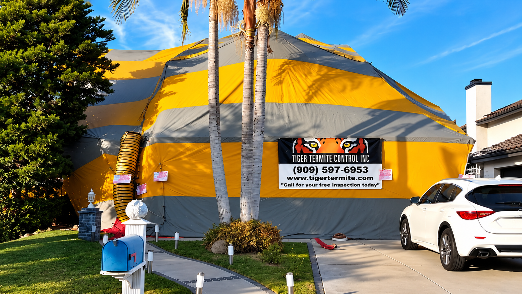 A Chino Hills home enclosed in a Tiger Termite Control fumigation tent on a sunny day